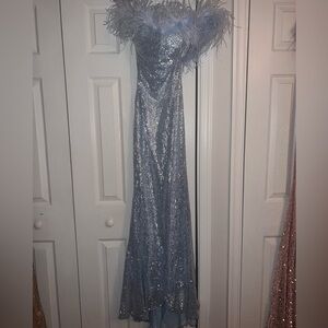 Elegant Silver Sequin Gown with Feather Details